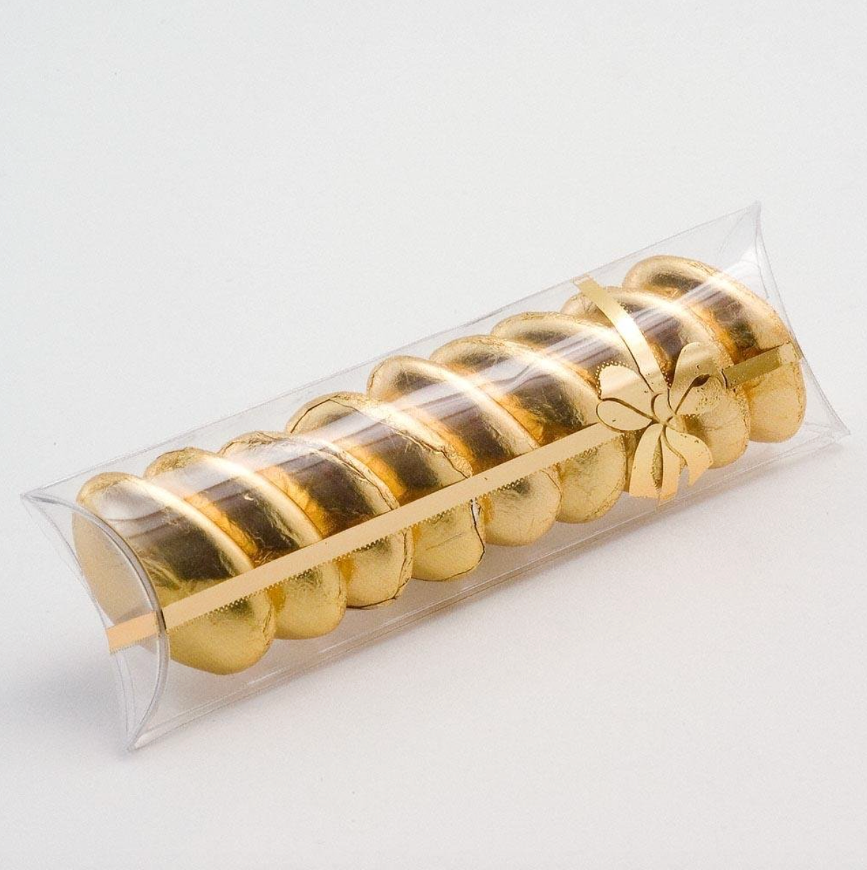 Gold sweets in transparent tube box