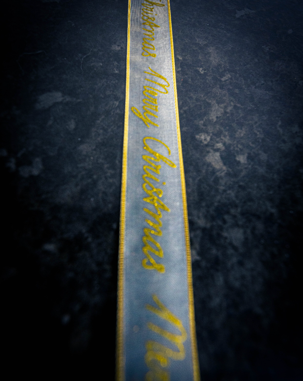 Cake Ribbon saying Merry Christmas in Gold Cursive Font
