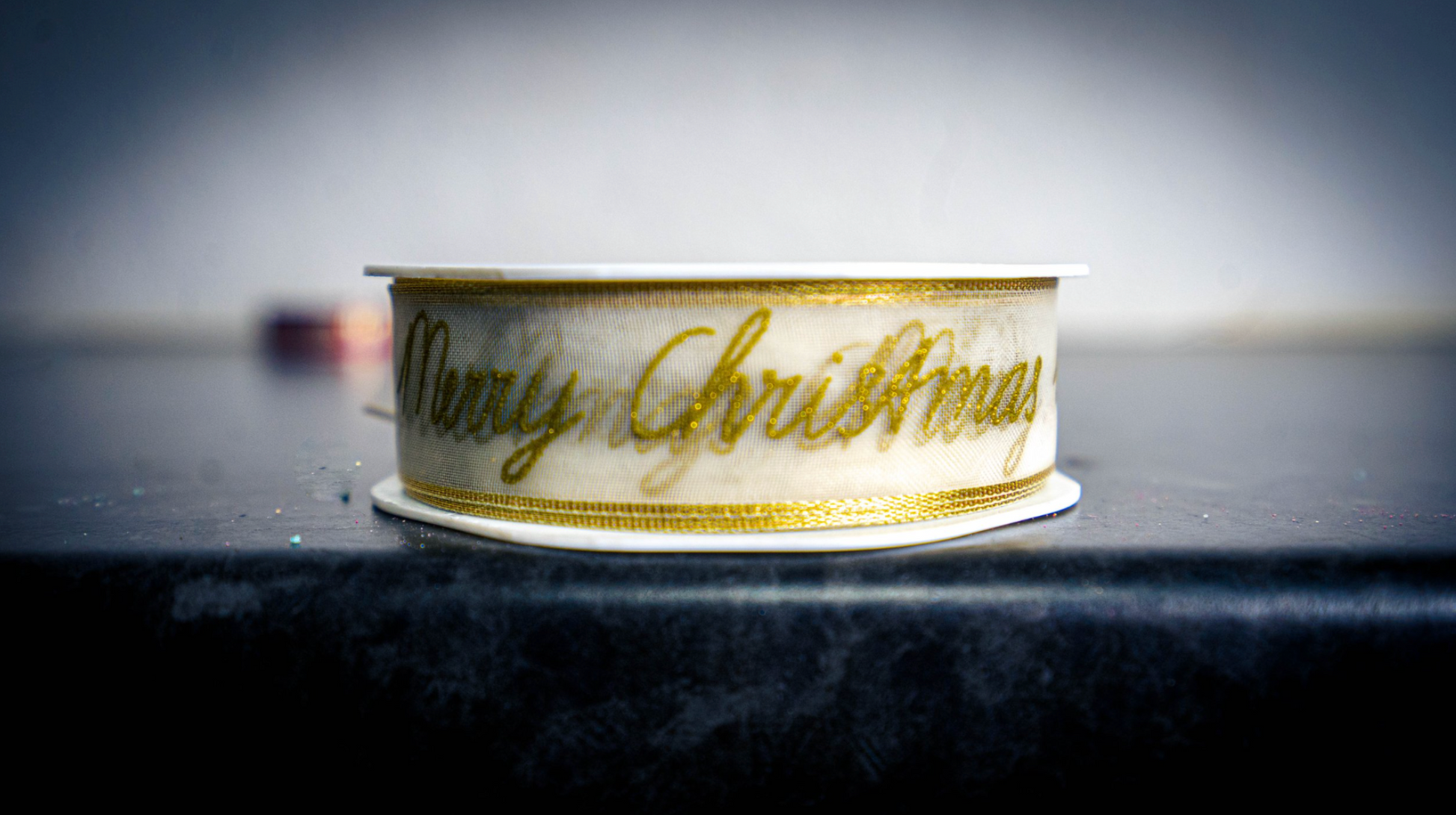 Festive Ribbon, gold writing saying Merry Christmas